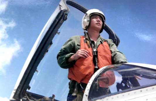 Pilot Cina, Wang Wei, berdiri di kokpit pesawat jet. Setelah tabrakan dengan pesawat pengintai Angkatan Laut AS pada 1 April 2001, para pejabat Cina melaporkan bahwa Wang terjun payung dari pesawat tempur F-8 di atas Laut Cina Selatan dan diduga tewas.